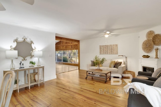 living room with light hardwood / wood-style flooring and ceiling fan