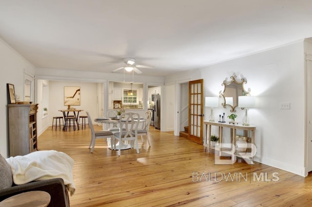 living room featuring light hardwood / wood-style flooring and ceiling fan