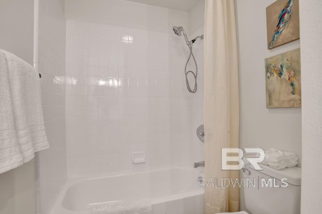 bathroom featuring shower / bathtub combination with curtain and toilet