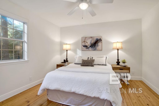 bedroom with ceiling fan and light hardwood / wood-style floors