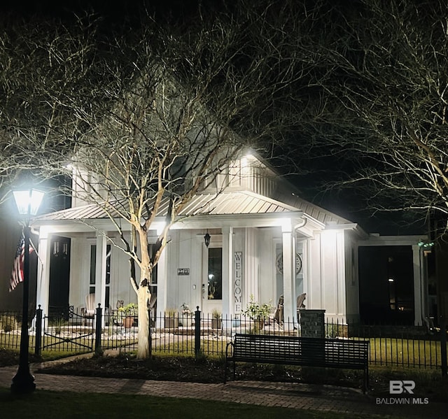 view of front of house with a fenced front yard and metal roof