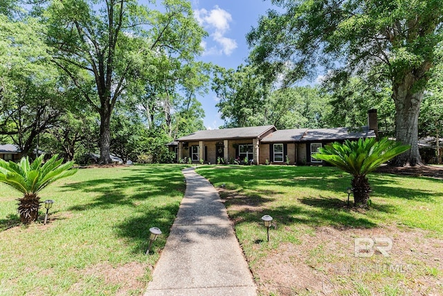 single story home featuring a front lawn