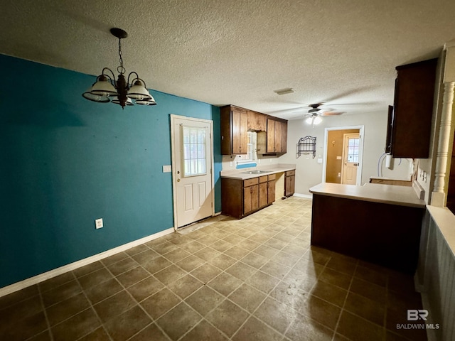 43265 Jones Rd, Bay Minette, AL 36507 - kitchen with a ceiling fan, light countertops, a chandelier, a textured ceiling, and dark tile patterned flooring