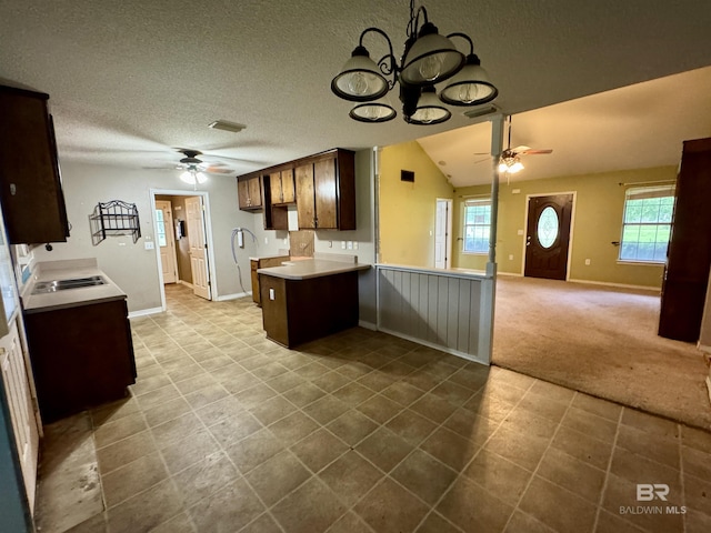43265 Jones Rd, Bay Minette, AL 36507 - kitchen with ceiling fan, light countertops, dark tile patterned flooring, a peninsula, and a textured ceiling