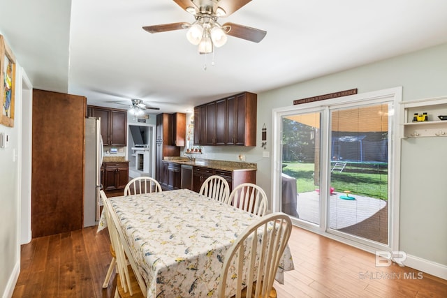 dining space with baseboards, a ceiling fan, and hardwood / wood-style flooring