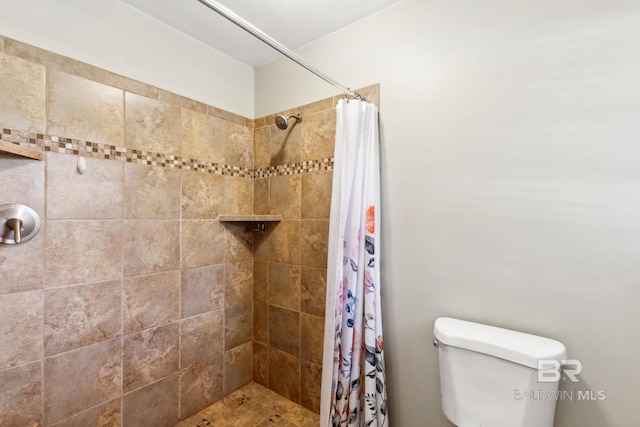 full bath with toilet and a tile shower