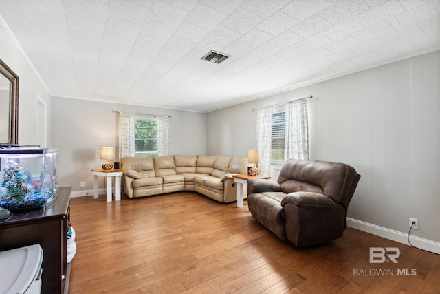 living room featuring ornamental molding and hardwood / wood-style floors