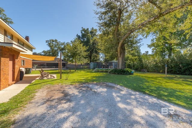 view of yard featuring fence, a patio area, and a trampoline