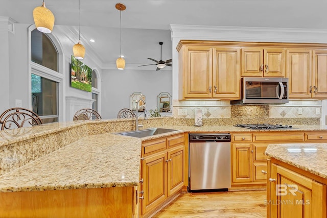 30230 Dolive Rdg, Daphne, AL 36527 - kitchen featuring stainless steel appliances, light wood finished floors, light stone countertops, ceiling fan, and ornamental molding
