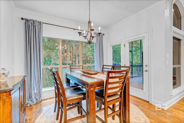 30230 Dolive Rdg, Daphne, AL 36527 - dining space with a chandelier, light wood-style floors, plenty of natural light, and ornamental molding