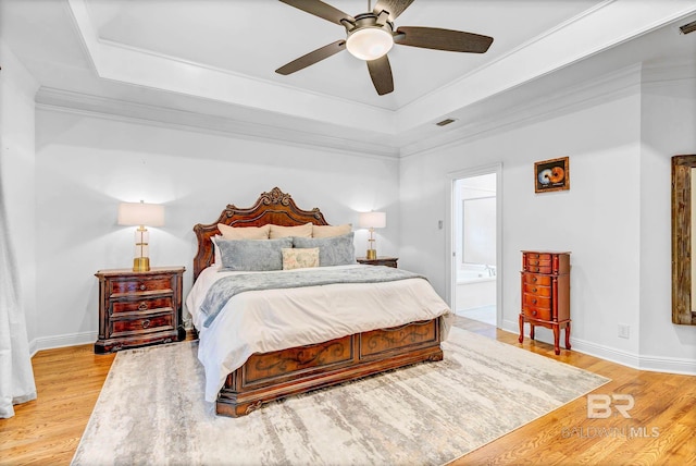 30230 Dolive Rdg, Daphne, AL 36527 - bedroom featuring a raised ceiling, light wood-type flooring, crown molding, ensuite bath, and ceiling fan