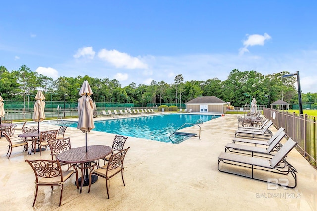 30230 Dolive Rdg, Daphne, AL 36527 - community pool featuring a patio area and view of wooded area