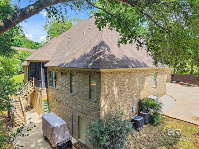 30230 Dolive Rdg, Daphne, AL 36527 - view of property exterior featuring a patio area, stairway, brick siding, and a sunroom