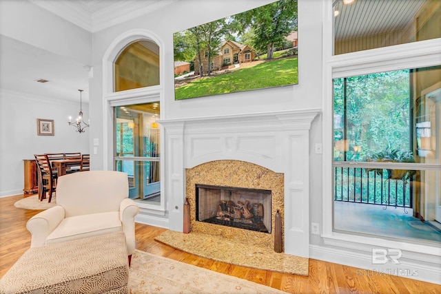 30230 Dolive Rdg, Daphne, AL 36527 - living room with ornamental molding, wood finished floors, a chandelier, and a premium fireplace