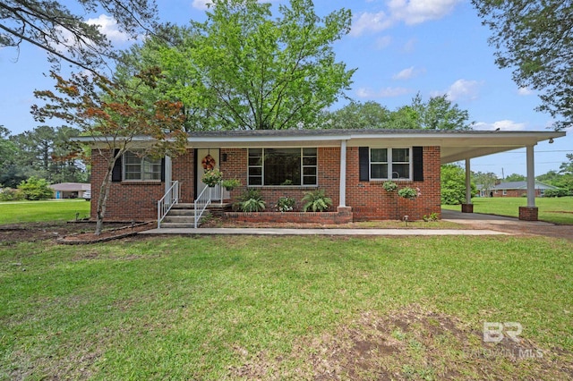ranch-style home featuring a front lawn, brick siding, and a carport