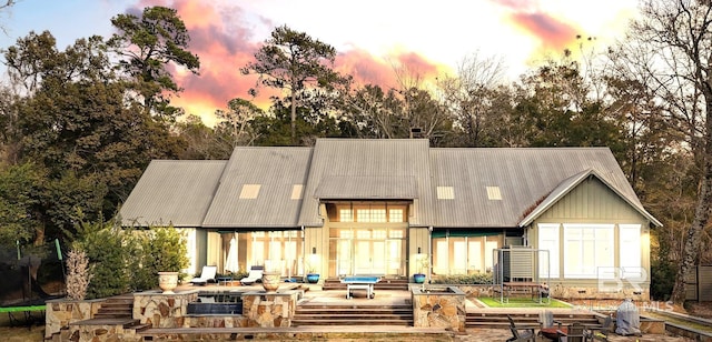 back of house at dusk with metal roof