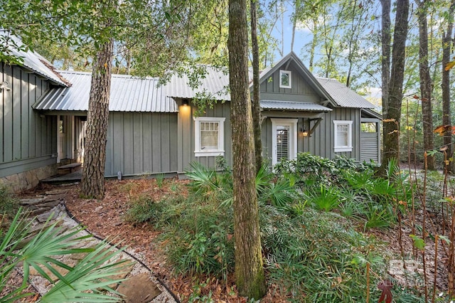 view of front facade with board and batten siding and metal roof