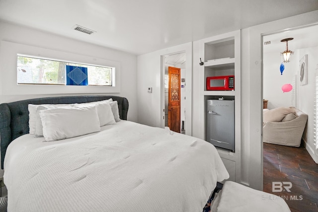 bedroom featuring visible vents and stone finish floor