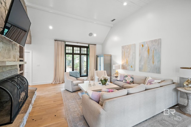 living area with baseboards, light wood-type flooring, a fireplace, high vaulted ceiling, and recessed lighting