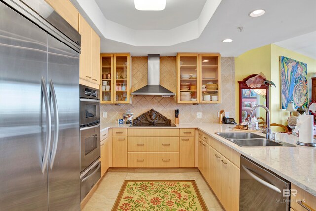 kitchen with light brown cabinets, wall chimney range hood, stainless steel appliances, sink, and light tile patterned floors