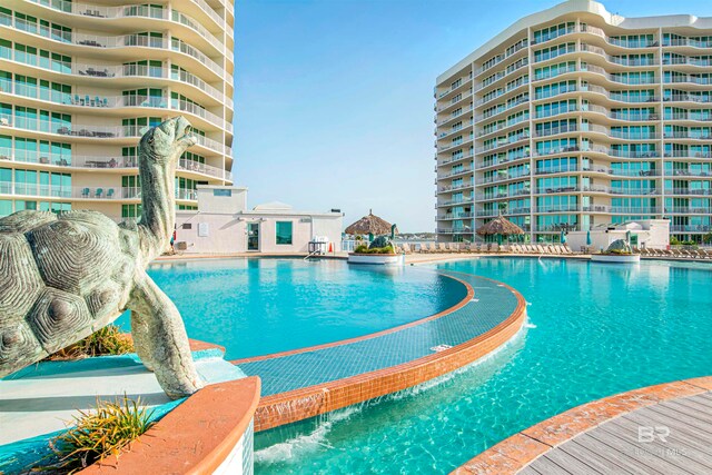 view of swimming pool with pool water feature