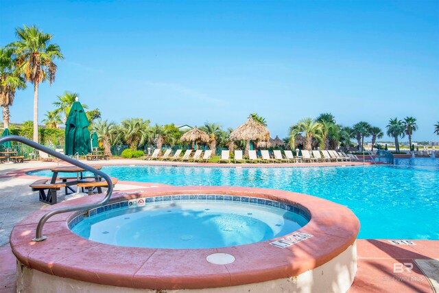 view of pool with a hot tub