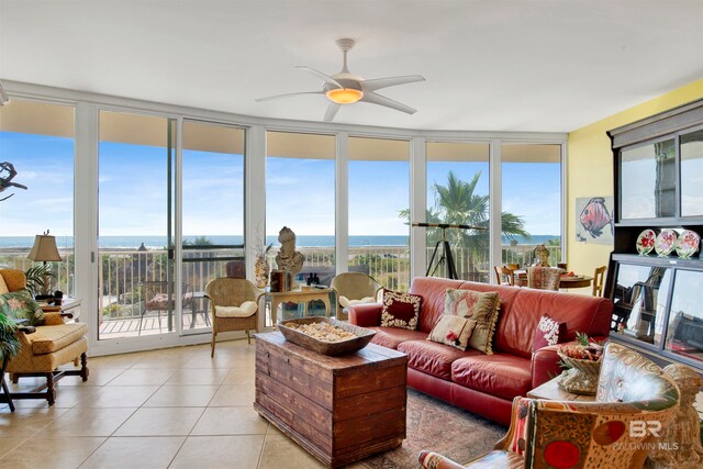 sunroom / solarium with ceiling fan, a water view, and plenty of natural light