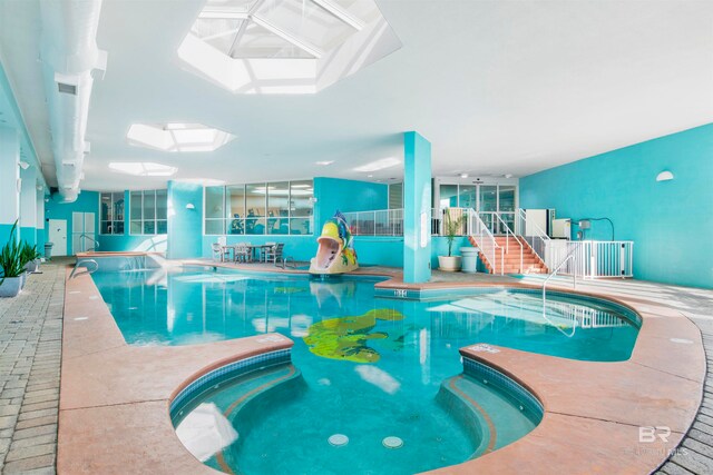 view of pool featuring a skylight