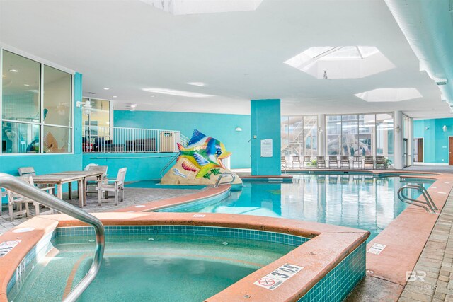 view of swimming pool with a skylight