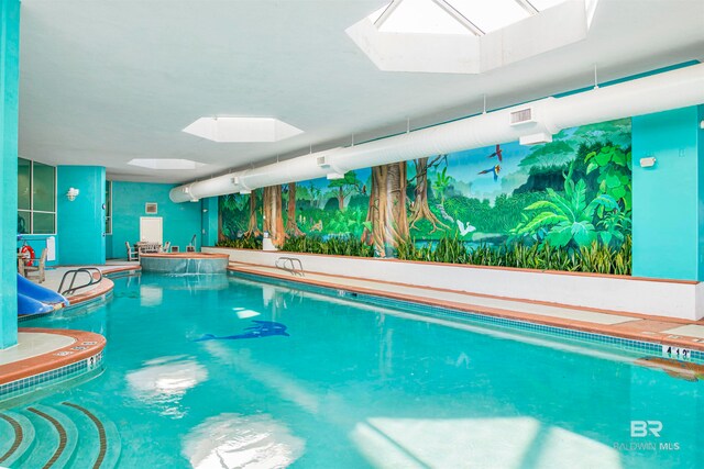 view of swimming pool featuring a skylight