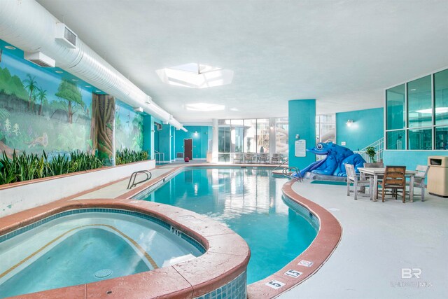 view of pool featuring a skylight