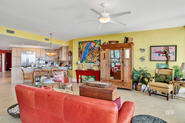 living room with light tile patterned floors and ceiling fan