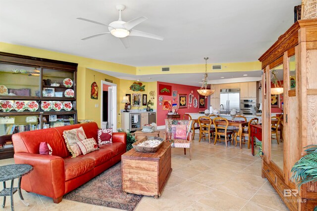 tiled living room featuring ceiling fan