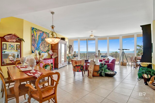 dining area with expansive windows, ceiling fan, and light tile patterned floors