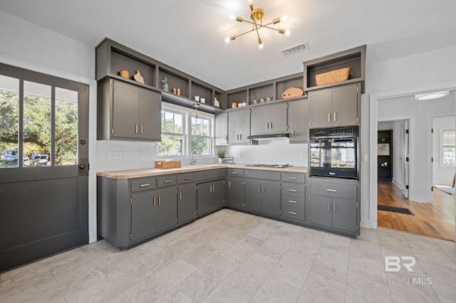 25121 State St, Elberta, AL 36530 - kitchen featuring tasteful backsplash, stainless steel gas cooktop, sink, gray cabinets, and oven