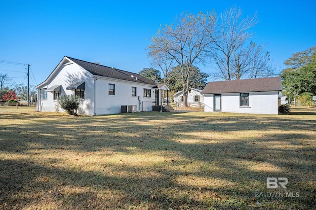 25121 State St, Elberta, AL 36530 - rear view of property with a yard and central AC unit