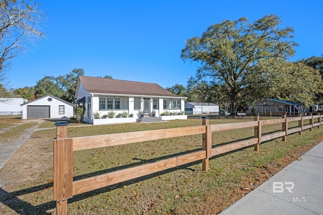 25121 State St, Elberta, AL 36530 - view of front of home featuring a porch, a garage, an outdoor structure, and a front lawn