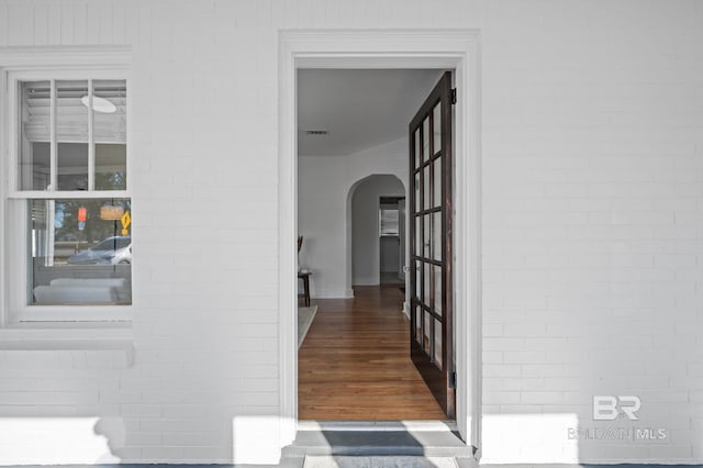 25121 State St, Elberta, AL 36530 - hall with dark hardwood / wood-style floors and brick wall