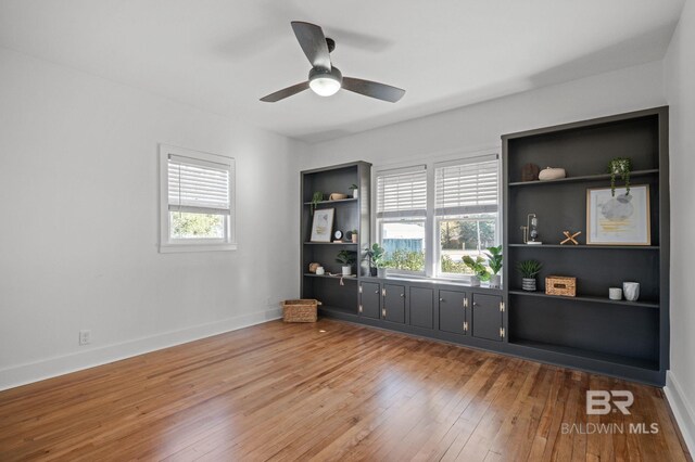 25121 State St, Elberta, AL 36530 - empty room featuring ceiling fan, built in features, and wood-type flooring