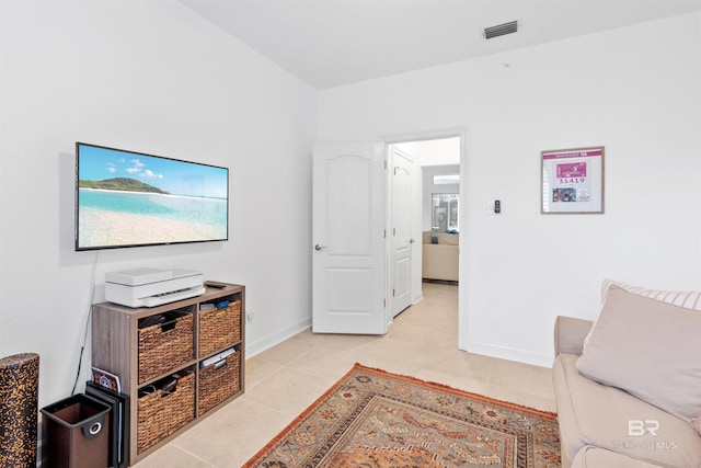 living room with visible vents, baseboards, and light tile patterned flooring