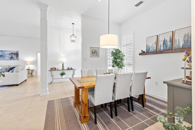 dining space featuring light tile patterned floors, visible vents, baseboards, ornamental molding, and decorative columns