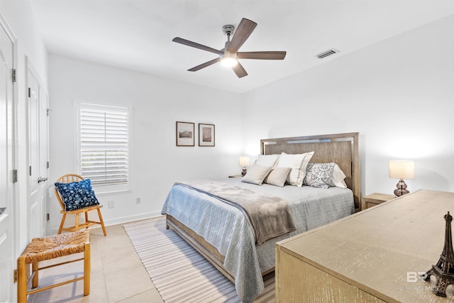 bedroom with baseboards, visible vents, ceiling fan, and light tile patterned flooring