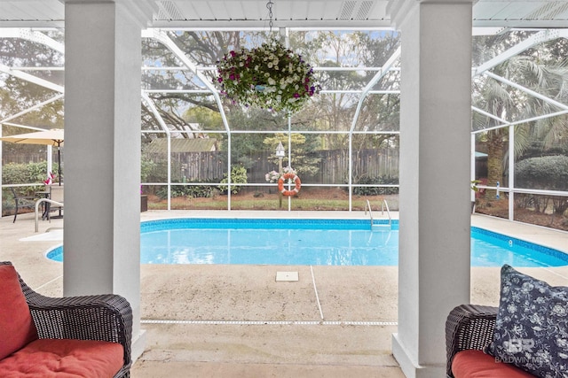 pool featuring a lanai and a patio area