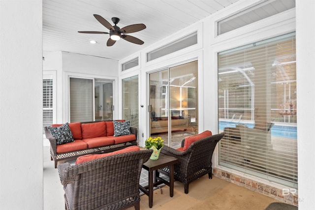 sunroom featuring a ceiling fan