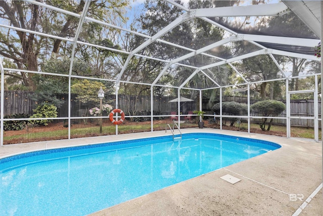 view of pool featuring a fenced in pool, glass enclosure, a fenced backyard, and a patio