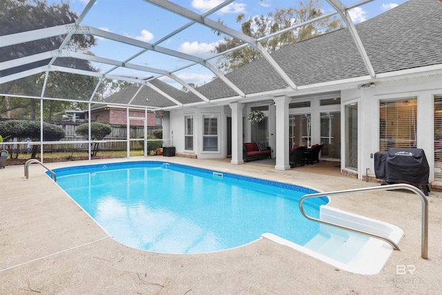 view of swimming pool with glass enclosure, fence, a fenced in pool, and a patio