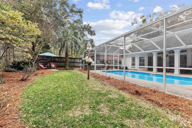 view of pool featuring a fenced in pool, glass enclosure, a fenced backyard, and a lawn