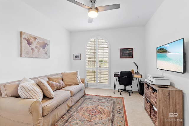 living area featuring light tile patterned floors and a ceiling fan