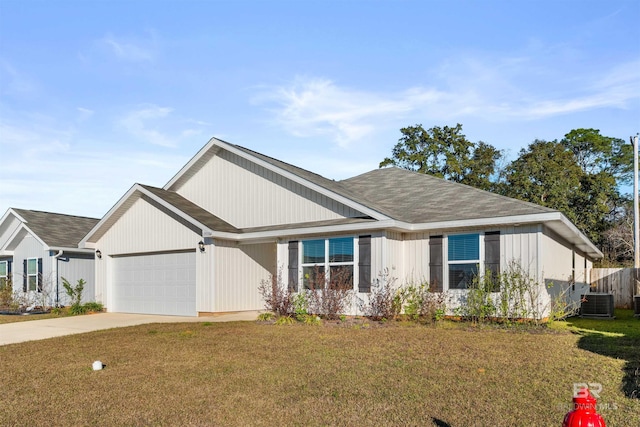 view of front facade with central AC unit, a front yard, and a garage