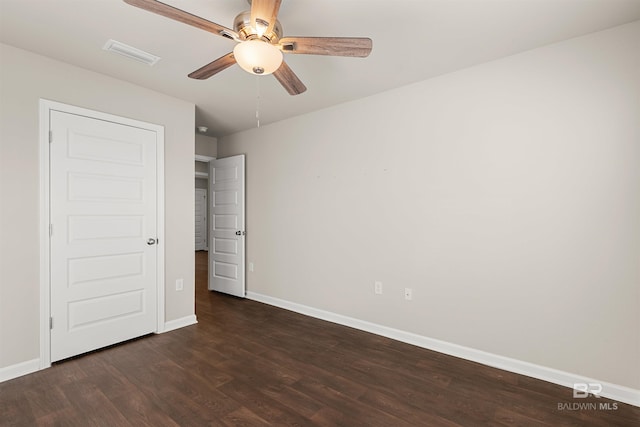 unfurnished bedroom featuring ceiling fan and dark wood-type flooring